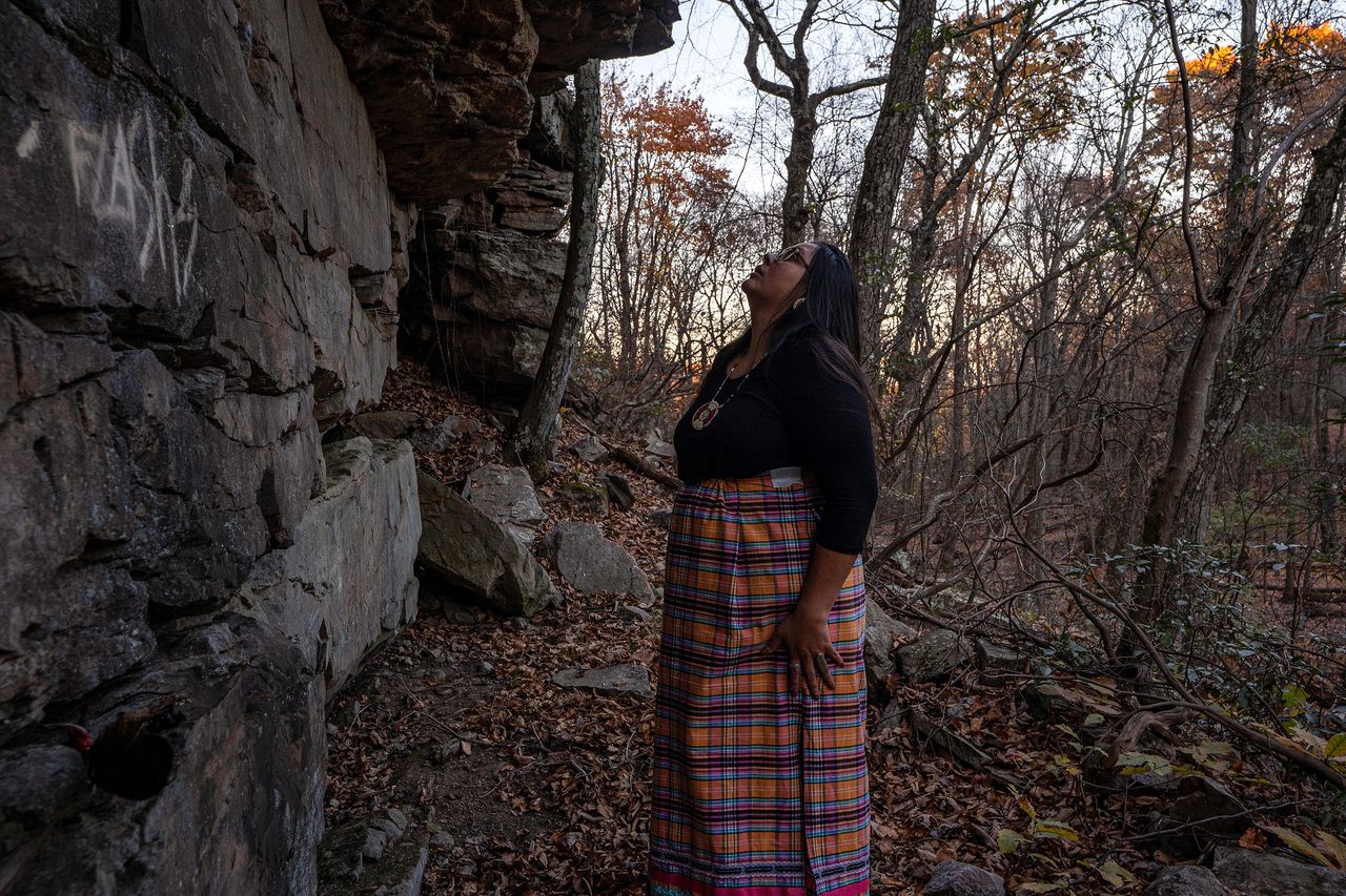 Lauryn examines an ancient rock shelter inside the Delaware Water Gap National Recreation Area, which was used by Lenape ancestors for countless millennia. Recent vandalism has marred the surface of the wall.
