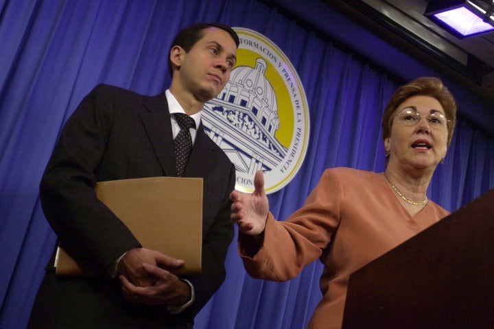 Dominican Secretary for Commerce and Industry Sonia Guzman, right, talks to the media accompanied by Orlando Jorge Mera, at the presidential palace in Santo Domingo, Dominican Republic, March 16, 2004. Mera, the Dominican Republic's minister of the environment and natural resources, was shot and killed in his office on Monday, June 6, 2022, according to officials. (AP Photo/Walter Astrada, File)