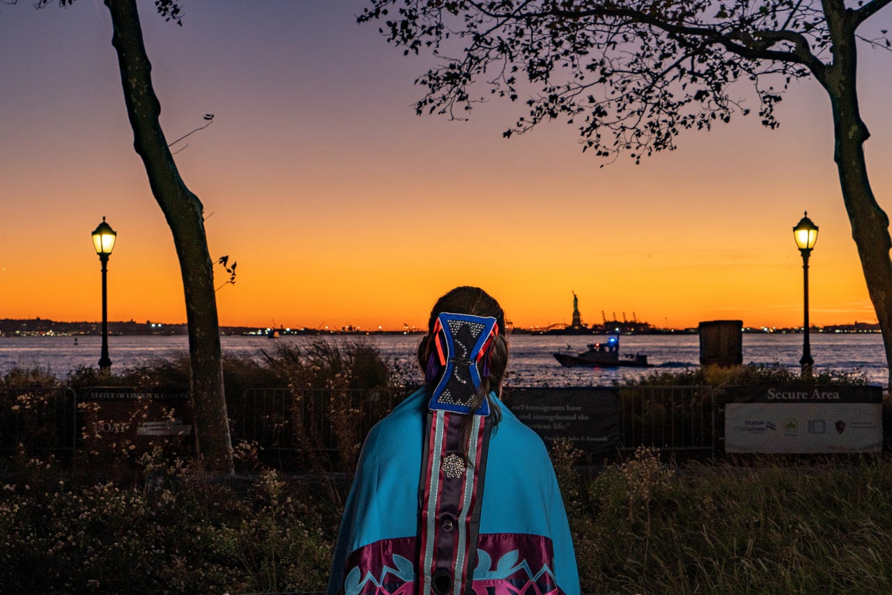 River Whittle gazes out toward the Statue of Liberty, which welcomes millions from around the globe into Lenapehoking. Not far is a historical meeting place where Lenape residents would welcome visitors from other Indigenous nations for thousands of years. Today, it can be immensely challenging for Lenape people to feel welcome and connected to their own homelands.