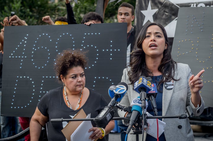 New York City Councilwoman Carlina Rivera, right, speaks at a 2018 rally for hurricane relief for Puerto Rico. Rivera is casting herself as a homegrown advocate for her community.