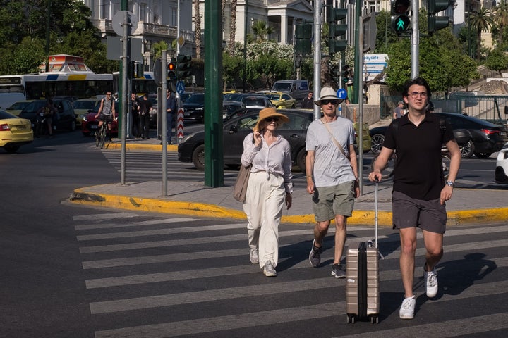 Tourist wearing hat are walking in the center if Athens, Greece on June 1, 2022. Greece was in high temperatures today. (Photo by Nikolas Kokovlis/NurPhoto via Getty Images)