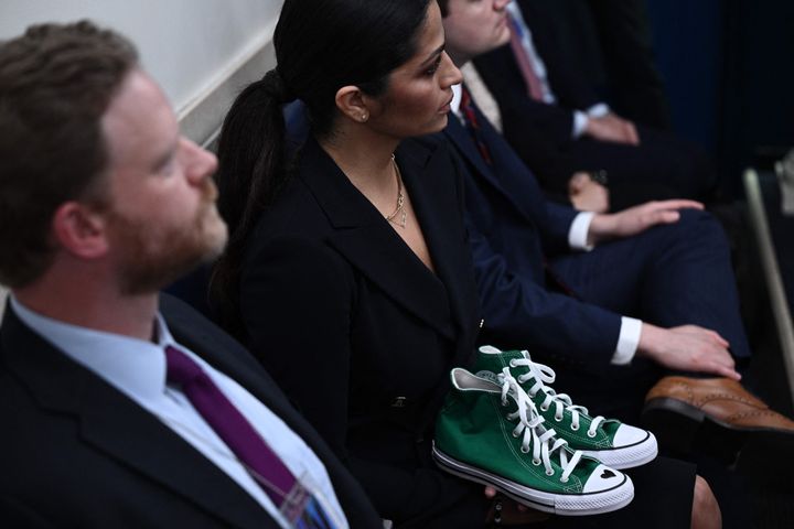 Camila Alves McConaughey holds the shoes of Maite Yuleana Rodriguez, a student who was killed in the mass shooting at Robb Elementary School, while Matthew McConaughey speaks in the White House briefing room Tuesday.