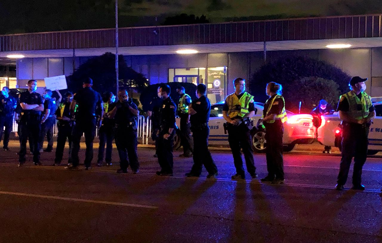 Officers form a line in front of a police precinct Wednesday, May 27, 2020, in Memphis, Tenn., during a protest over the death of George Floyd in police custody earlier in the week in Minneapolis.