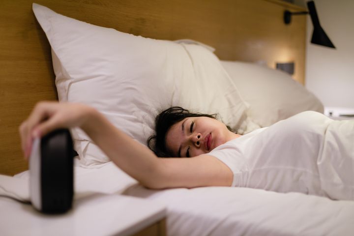 Stick to a regular wakeup time and don't stress about the bedtime quite yet.
