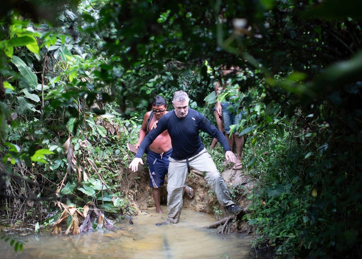 British journalist Dom Phillips (right) and a Yanomami Indigenous man walk in Maloca Papiu village, Roraima state, Brazil, Nov. 2019. Phillips and Indigenous affairs expert Bruno Araujo Pereira have been reported missing in a remote part of Brazil's Amazon region, a local Indigenous association said Monday, June 6, 2022.