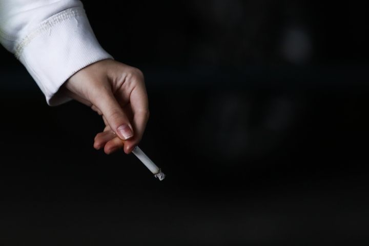 A woman smokes a cigarette in Krakow, Poland on March 28, 2022. (Photo by Jakub Porzycki/NurPhoto via Getty Images)