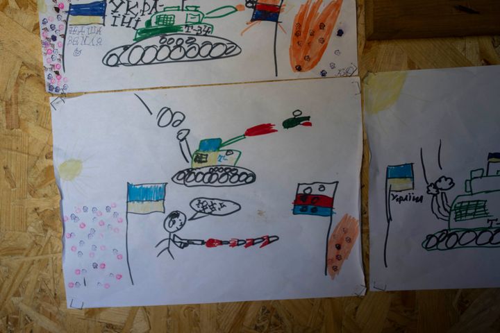Drawings made by Ukrainian children decorate a sleeping area in a Ukrainian trench near the front lines in the Donetsk region, eastern Ukraine, on June 8, 2022.