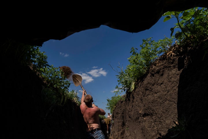 Ukrainian servicemen dig trenches near the frontline in Donetsk region, eastern Ukraine, on June 8, 2022.