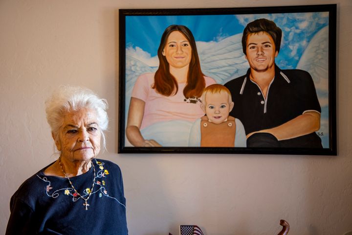 Donna Casasanta with a painting showing her late son, Harold Dean Clouse, with his wife, Tina Gail Linn, and their daughter, Holly Marie Clouse, at Casasanta's Florida home in January.