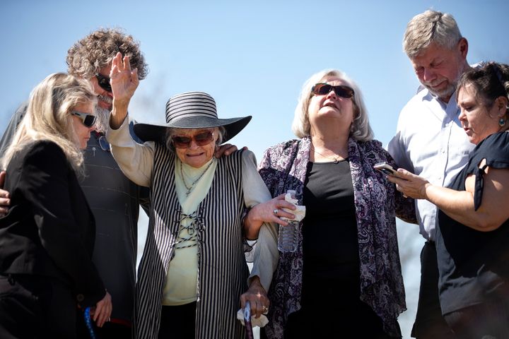 The family of Harold Dean Clouse and his wife, Tina Gail Linn, pray and embrace at their gravesite in Harris County, Texas, in March after the couple's remains, which were found in 1981, were positively identified late last year.