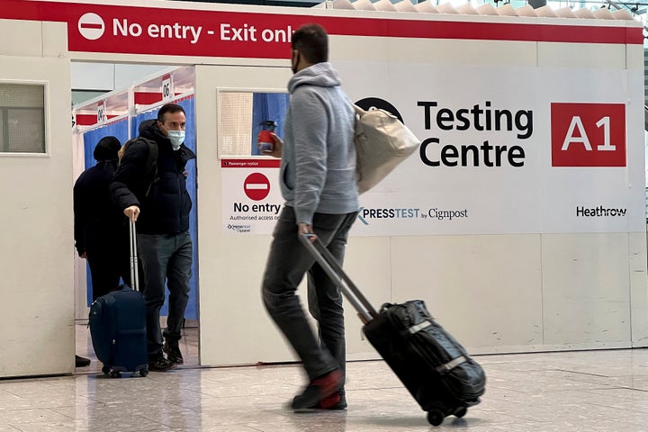 Passengers get a COVID-19 test at Heathrow Airport in London on Nov. 29, 2021.