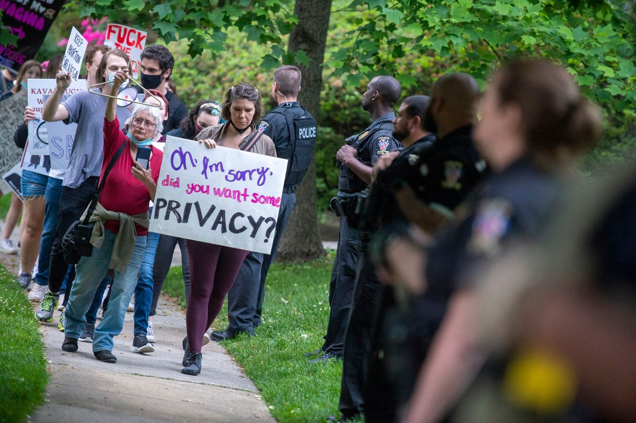 Abortion rights advocates demonstrate as police officers stand by near the home of Supreme Court Chief Justice John Roberts on May 182 in Chevy Chase, Maryland. Protests have been organized intermittently outside the homes of some justices after the disclosure of a draft opinion that would overturn Roe v. Wade.
