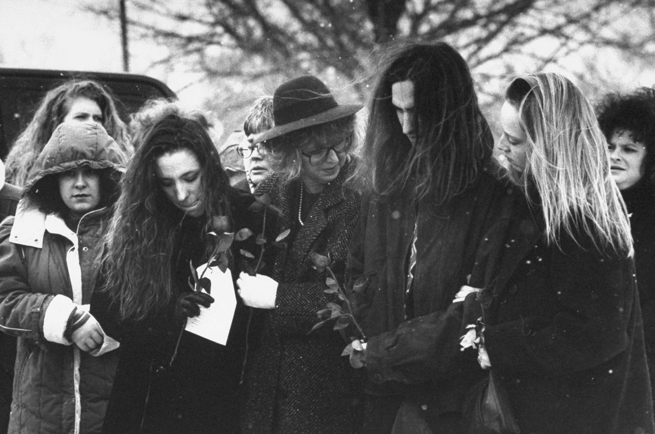 Rita Gunn (center), the ex-wife of murdered obstetrician David Gunn, bows her head as she stands over his casket flanked by daughter Wendy and son David Jr., who is with his girlfriend, during a graveside service on March 13, 1993.