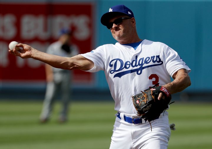 Former Los Angeles Dodger Steve Sax throws after fielding a ball during batting practice before an old-timers baseball game in Los Angeles, Saturday, June 10, 2017.