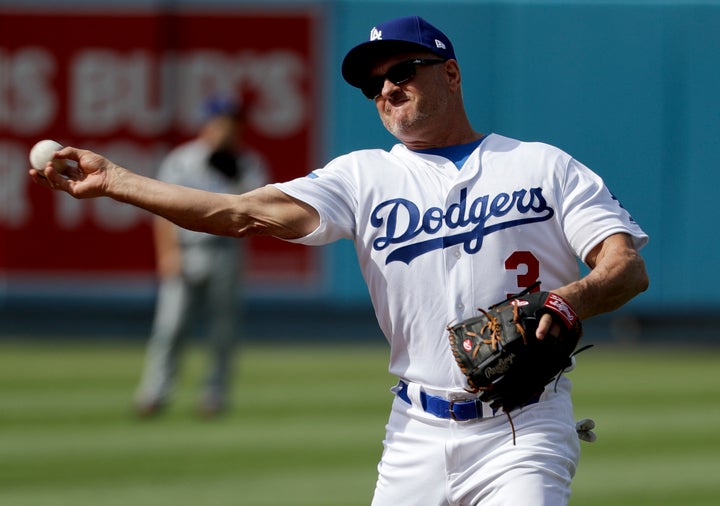 Former Los Angeles Dodger Steve Sax throws after fielding a ball during batting practice before an old-timers baseball game in Los Angeles, Saturday, June 10, 2017.