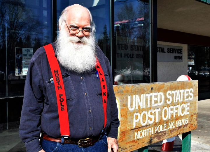 Santa Claus stands in front of the North Pole post office, on April 24, 2022. A self-described "independent, progressive, democratic socialist" whose legal name is Santa Claus has gotten attention but has not been raising money.