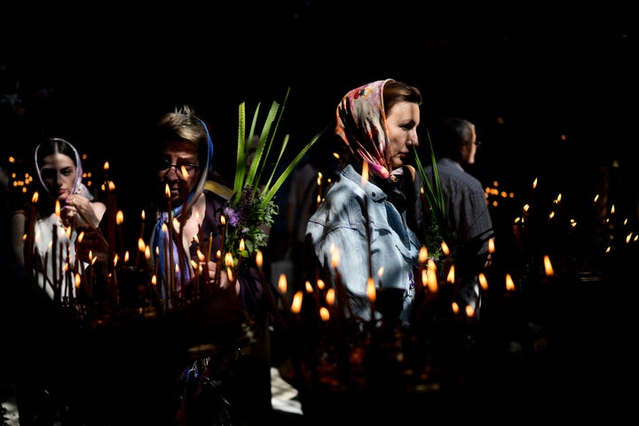 Women attend a mass at St. Volodymyr's Cathedral during Orthodox Pentecost in Kyiv, Ukraine, on June 12, 2022. The Orthodox Church celebrates Pentecost on the fifth Sunday after Easter. 