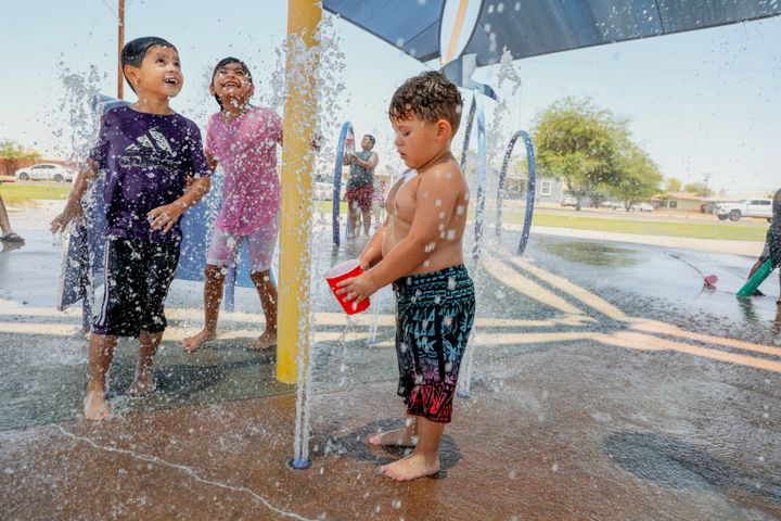 Kids play at a water park as the temperature reaches 115 degrees on June 12, 2022, in Imperial, California.