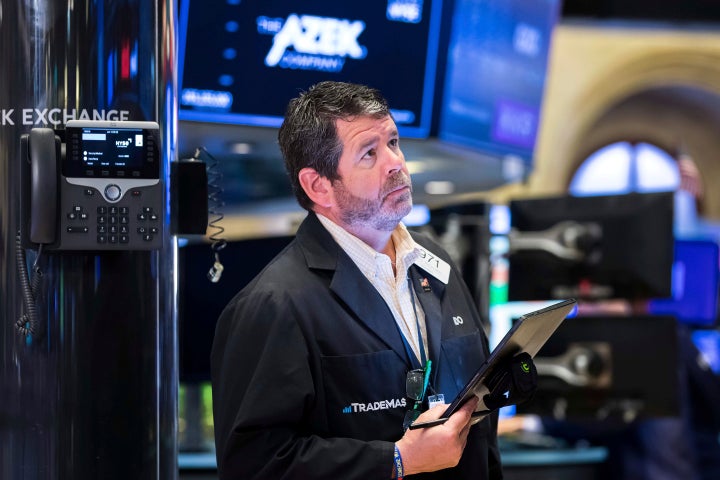 In this photo provided by the New York Stock Exchange, trader James Macgilvray works on the floor, Monday, June 13, 2022. Fears about a possible recession are pounding markets worldwide on Monday, and Wall Street's S&P 500 tumbled into the maw of what's known as a bear market after sinking more than 20% below its record set early this year. (Courtney Crow/New York Stock Exchange via AP)