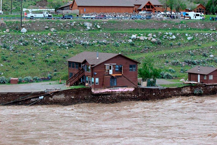 Yellowstone Floods Wipe Out Roads, Bridges, Strand Guests 15 In this image provided by Sam Glotzbach, the flooding Yellowstone River undercuts the river bank, threatening a house and a garage in Gardiner, Mont., on June 13, 2022. (Sam Glotzbach via AP)