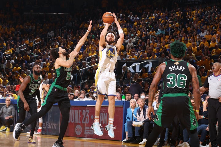 Klay Thompson shoots a three-point basket. 