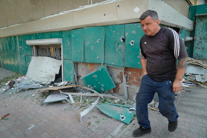A local resident passes by shrapnel traces following Russian night shelling in the town of Bakhmut, Donetsk region, Ukraine, on June 13, 2022.