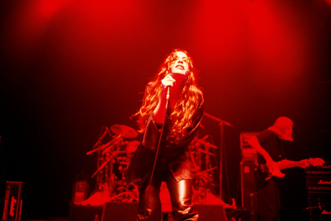 Alanis Morissette performing on stage. (Photo by Mick Hutson/Redferns)