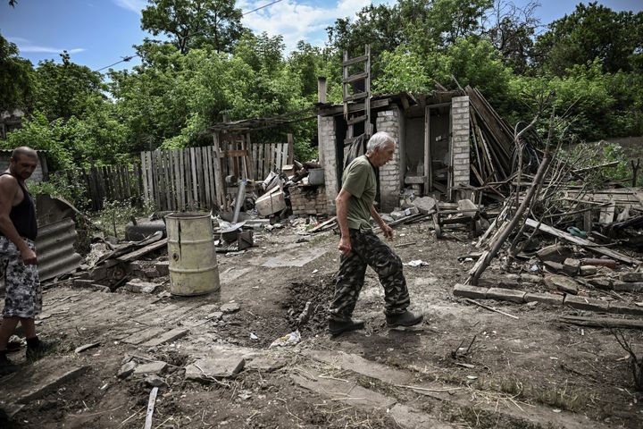 A man walks through the yard of a damaged house after shelling in which two people were killed in the city of Lysychansk in the eastern Ukrainian region of Donbas on June 13, 2022, amid Russian invasion of Ukraine.