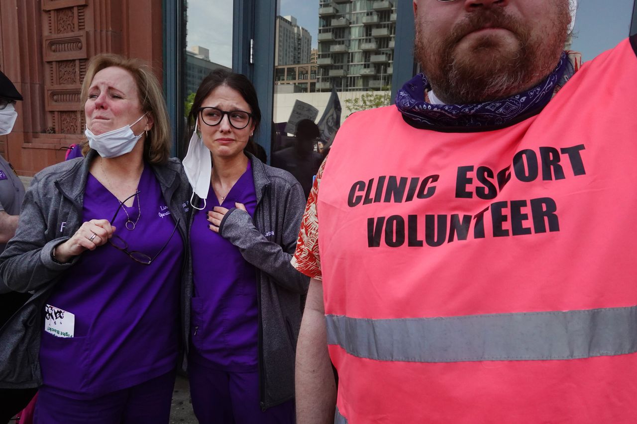 Employees at a family planning clinic in Chicago get emotional as thousands of abortion rights demonstrators march past their clinic chanting support last month.