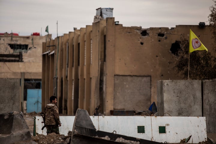 A Syrian Democratic Forces soldier keeps watch by a prison that was attacked by Islamic State militants, in Hassakeh, Syria, on Feb. 8, 2022. Hardly a day passes in northern Syria without Kurdish fighters and opposition gunmen backed by Turkey exchanging gunfire and shelling. 