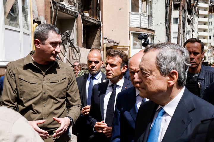 French President Emmanuel Macron, center, German Chancellor Olaf Scholz, partially obscured second right, and Italian Prime Minister Mario Draghi, right, visit Irpin on June 16, 2022.
