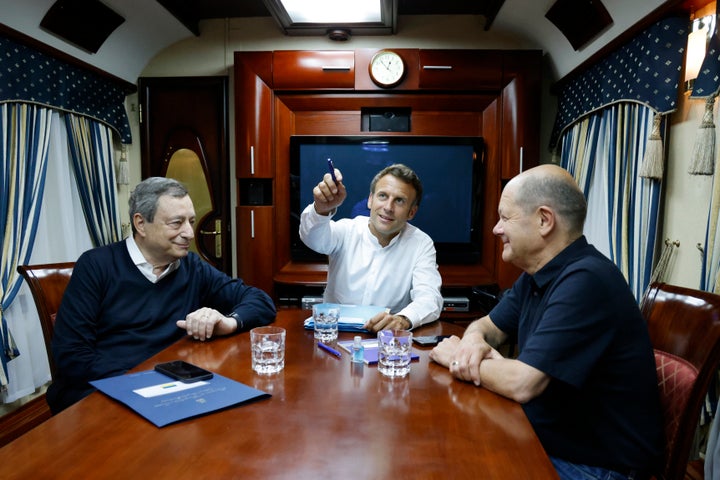 French President Emmanuel Macron, center, German Chancellor Olaf Scholz, right, and Italian Prime Minister Mario Draghi travel on board a train bound to Kyiv after departing from Poland on June 16, 2022. 