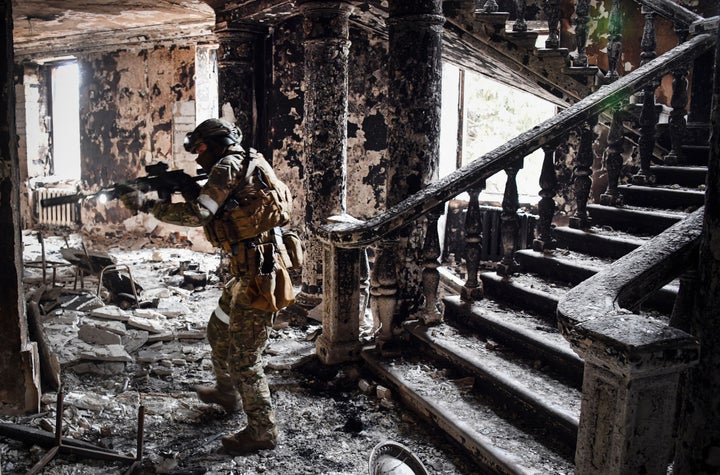 A Russian soldier patrols at the Mariupol drama theatre on April 12, 2022 in Mariupol, Ukraine. This picture was taken during a trip organized by the Russian military.