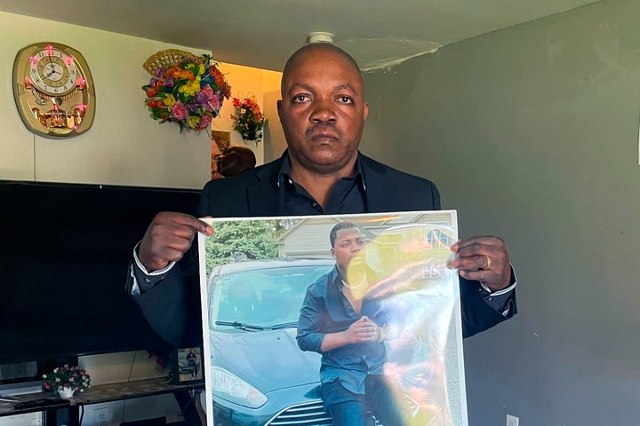 Peter Lyoya holds up a picture of his son Patrick Lyoya, 26, who was fatally shot during a traffic stop on April 4.