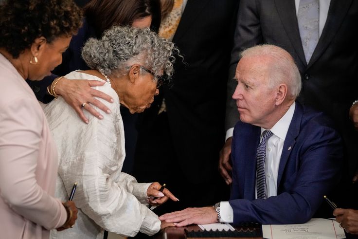 Opal Lee speaks with President Joe Biden after he signed the Juneteenth National Independence Day Act into law in the East Room of the White House on June 17, 2021.