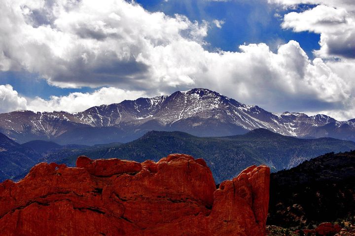 In this May 2, 2006, file photo, the sun breaks through the clouds to highlight the summit of Pikes Peak as seen from the Garden of the Gods in Colorado Springs, Colorado.