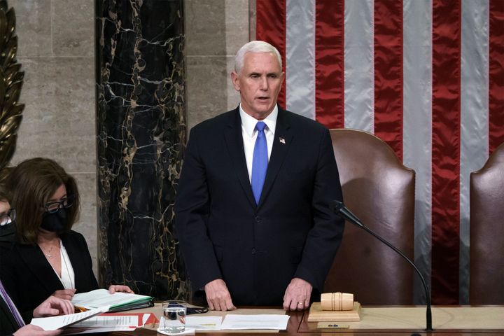 Vice President Mike Pence reads the final certification of Electoral College votes cast in the November 2020 presidential election. He and lawmakers worked through the night on Jan. 6, 2021 to complete the job after a pro-Trump mob stormed the Capitol with plans to kill Pence and other lawmakers to stop Joe Biden from becoming president.