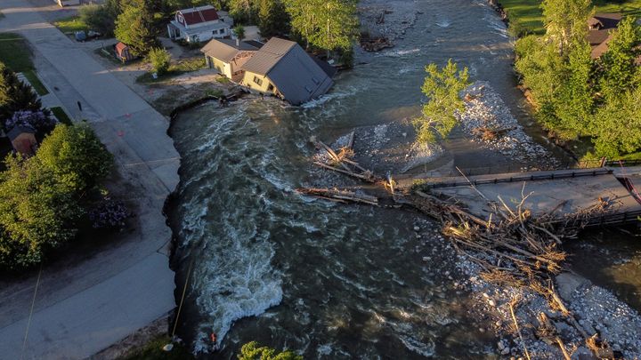 A house sits in Rock Creek after floodwaters washed away a road and a bridge in Red Lodge, Montana on June 15.