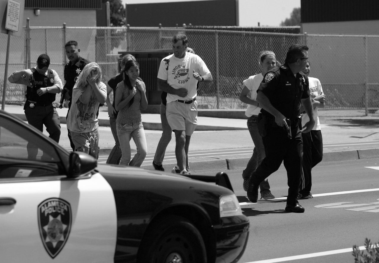 A police officer evacuates volunteer students wearing makeup to simulate injuries during a 2007 school shooting and mass evacuation drill at Lincoln Middle School in Alameda, California.