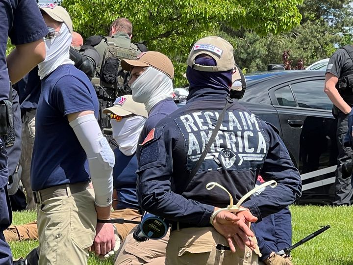 Authorities arrest members of the white supremacist group Patriot Front near an Idaho pride event Saturday, June 11, 2022, after they were found packed into the back of a U-Haul truck with riot gear. (Georji Brown via AP)