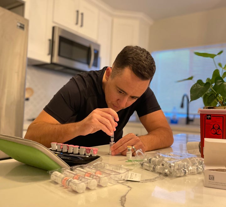 "I struggled through ... the discomfort of being the only male-identified patient in an all-female fertility clinic," writes James Bennett, pictured preparing one of two nightly injections required during the second week of the IVF cycle.