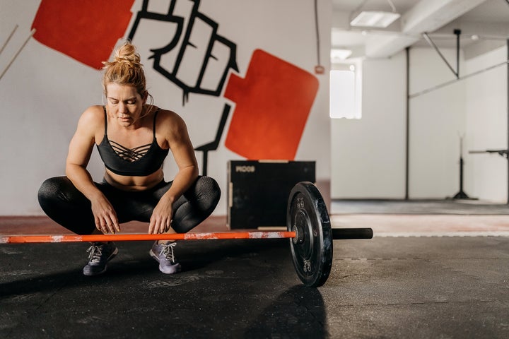 Tired woman resting after a workout set