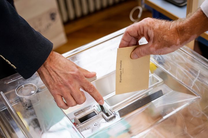 A voter casts his ballot at a voting station in Paris, Sunday, June 19, 2022. (AP Photo/Thomas Padilla)