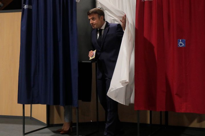 French President Emmanuel Macron leaves the voting booth Sunday, June 19, 2022 in Le Touquet, northern France. (AP Photo/Michel Spingler, Pool)