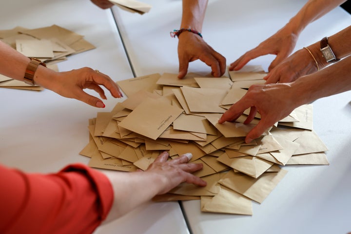 Volunteers count ballots in a polling station on June 19, 2022 in Bischeim, outside Strasbourg, eastern France.