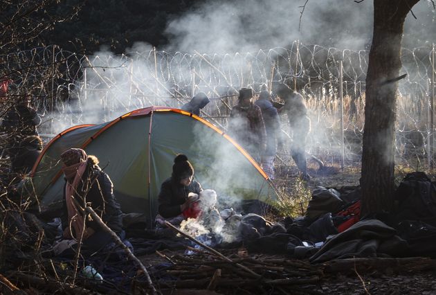 A woman feeds her baby in the camp on the border between Belarus and Poland in November 2021.