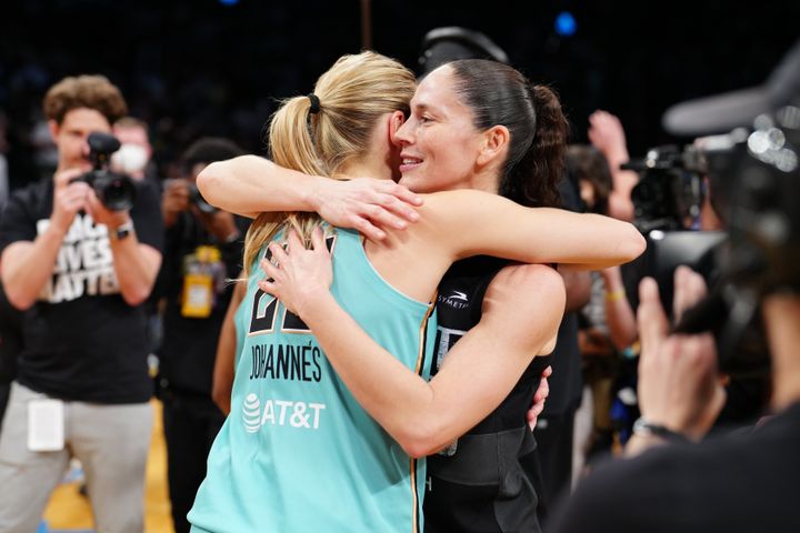 Marine Johannès of the New York Liberty hugs Sue Bird of the Seattle Storm after the game.