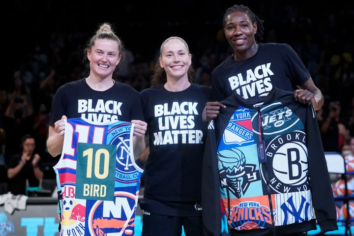 Sue Bird with former Storm teammates, New York Liberty forward Natasha Howard, right, and guard Sami Whitcomb during a pregame presentation.