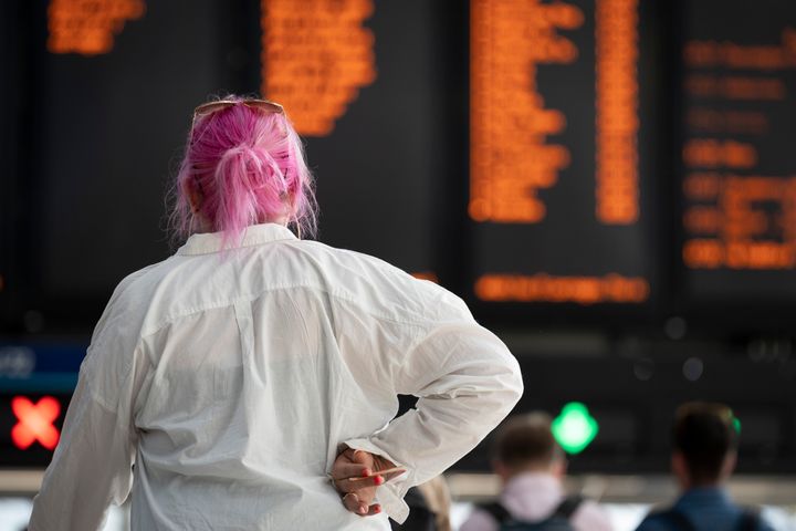 A passenger at Waterloo Station hours before the UK's rail network is shut down.