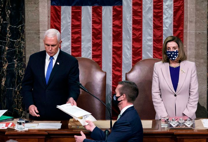 Vice President Mike Pence and House Speaker Nancy Pelosi preside over the certification of the Electoral College vote counts from the 2020 election after the insurrection on Jan. 6.